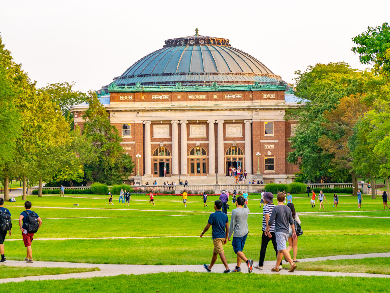 College students walk on the quad lawn of the University